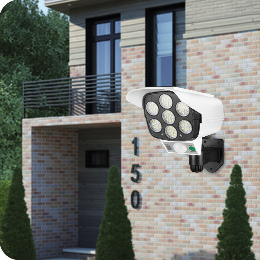 Security camera on a brick building exterior with greenery